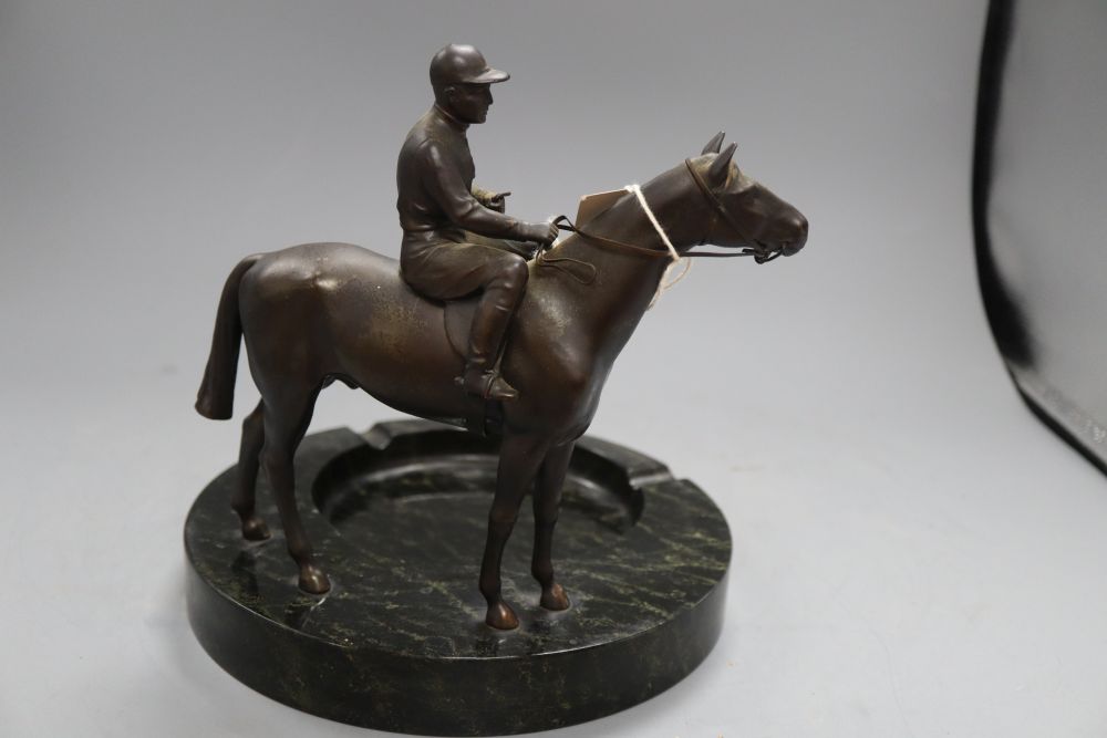 A spelter model of a horse and jockey, surmounted on a serpentine ashtray, height 23cm